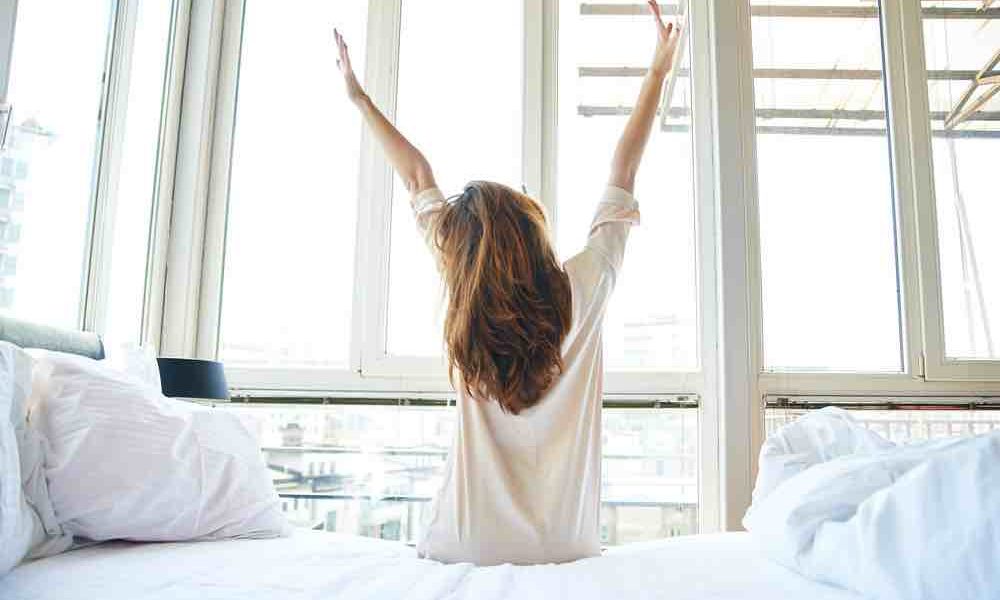 woman waking up and setting her goals for the day