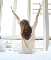 woman waking up and setting her goals for the day