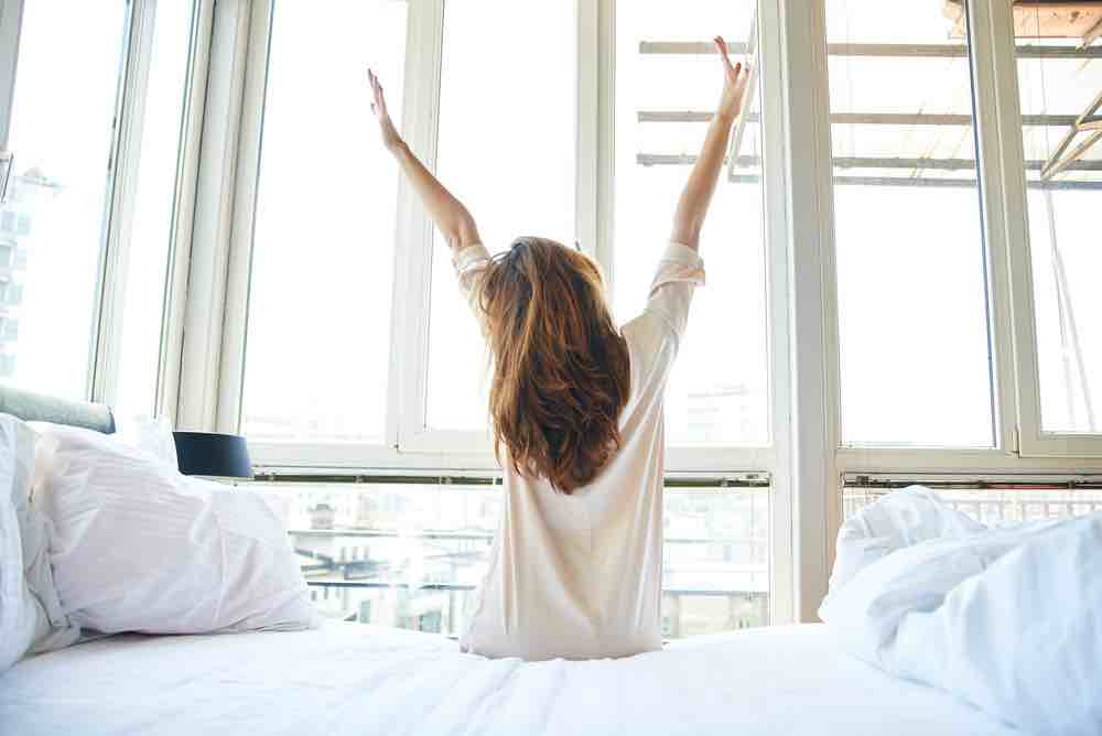 woman waking up and setting her goals for the day
