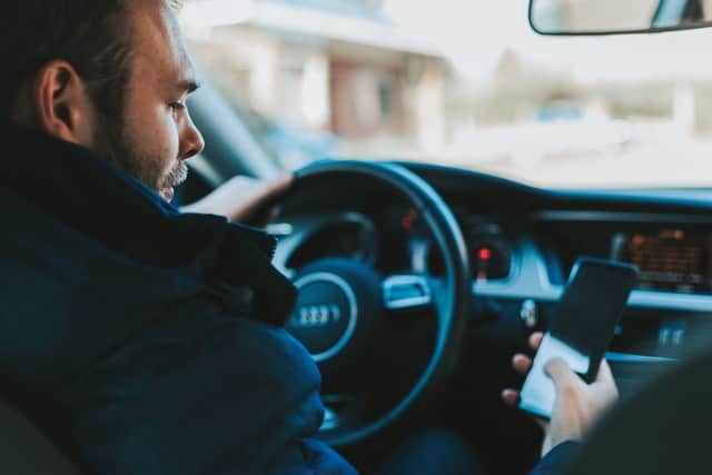 guy driving and texting at the same time