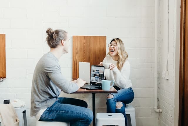 couple talking in a desk laughing