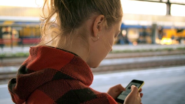 girl using her phone checking social media