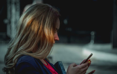 girl texting in the shadows