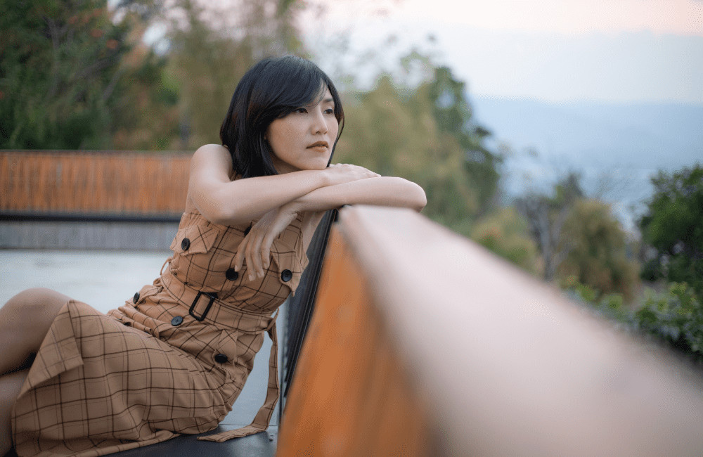 woman reflecting on bench in nature 