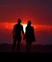 couple holding hands against the sunset