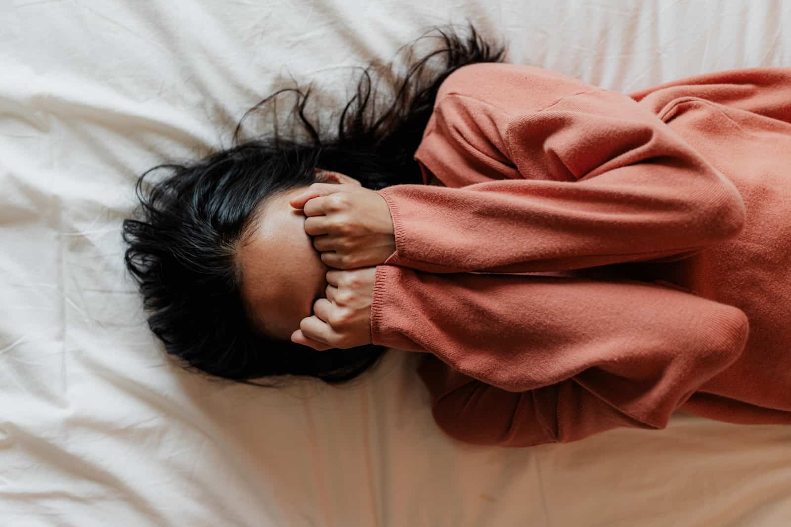 girl in bed with lots of emotions